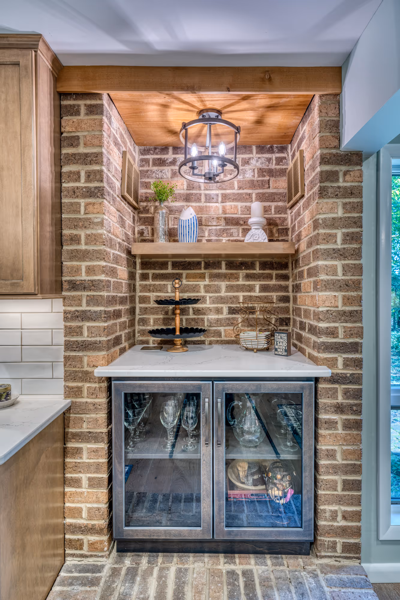 Stylish kitchen nook in Harrisburg, PA with rustic brick accents, wooden shelving, and modern lighting