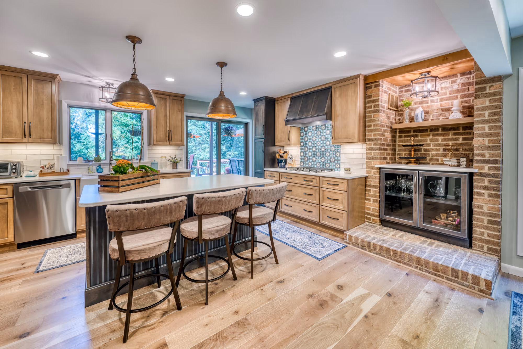 Modern kitchen with wood cabinets, a brick accent wall, and a unique blue tile backsplash in Harrisburg, PA.