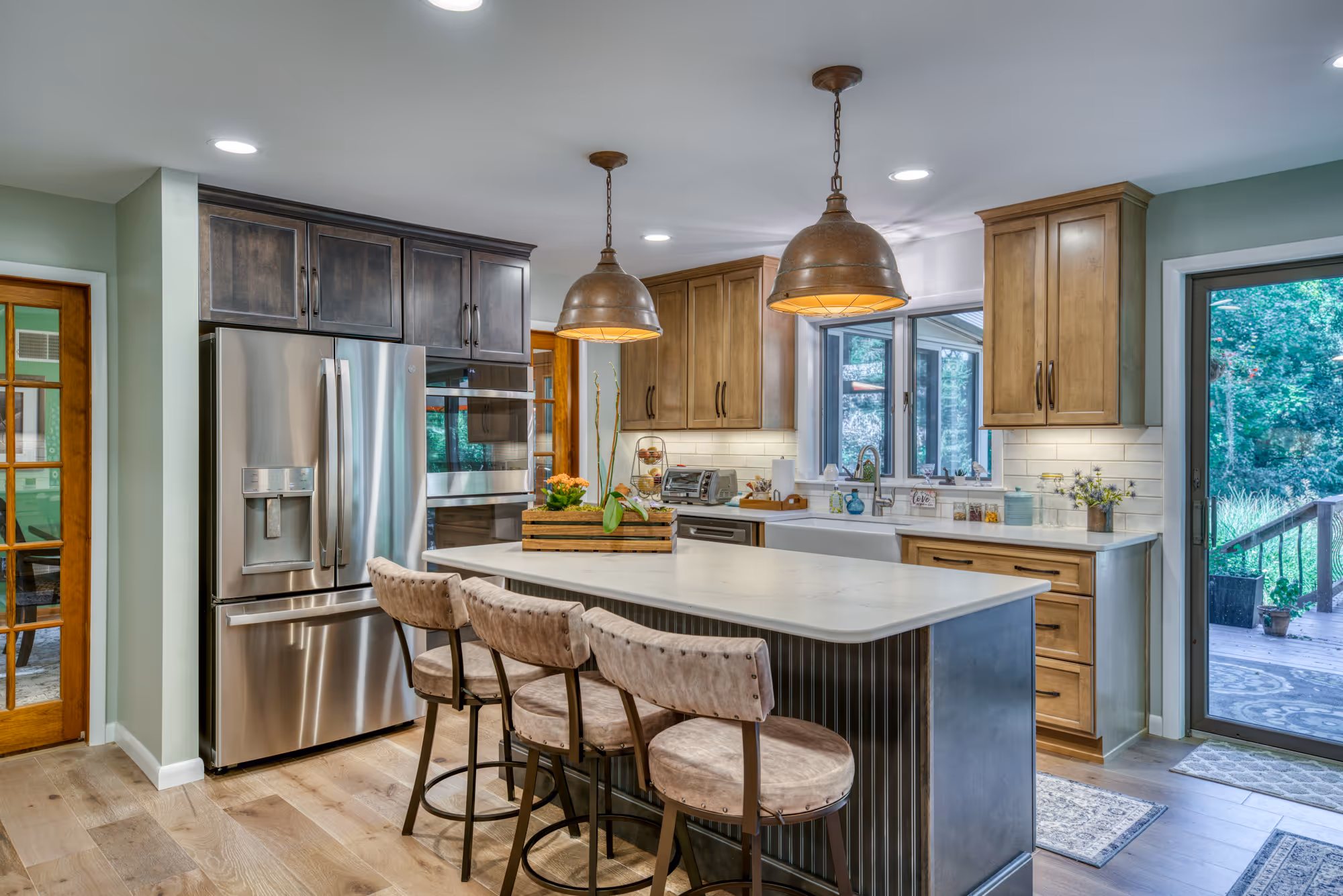 Modern kitchen in Harrisburg, PA featuring large pendant lighting, wood cabinets, and an inviting atmosphere.