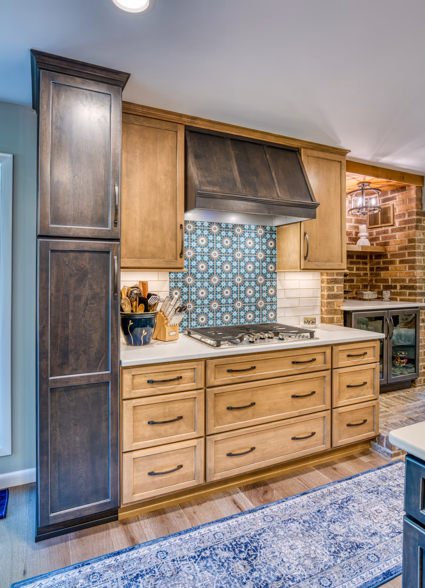 Stylish kitchen in Harrisburg, PA featuring dual wood tones, a decorative backsplash, and modern appliances.