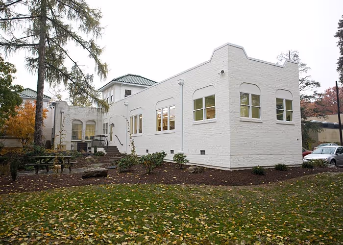 Modern exterior of a white brick building with large windows and greenery in Camp Hill, PA