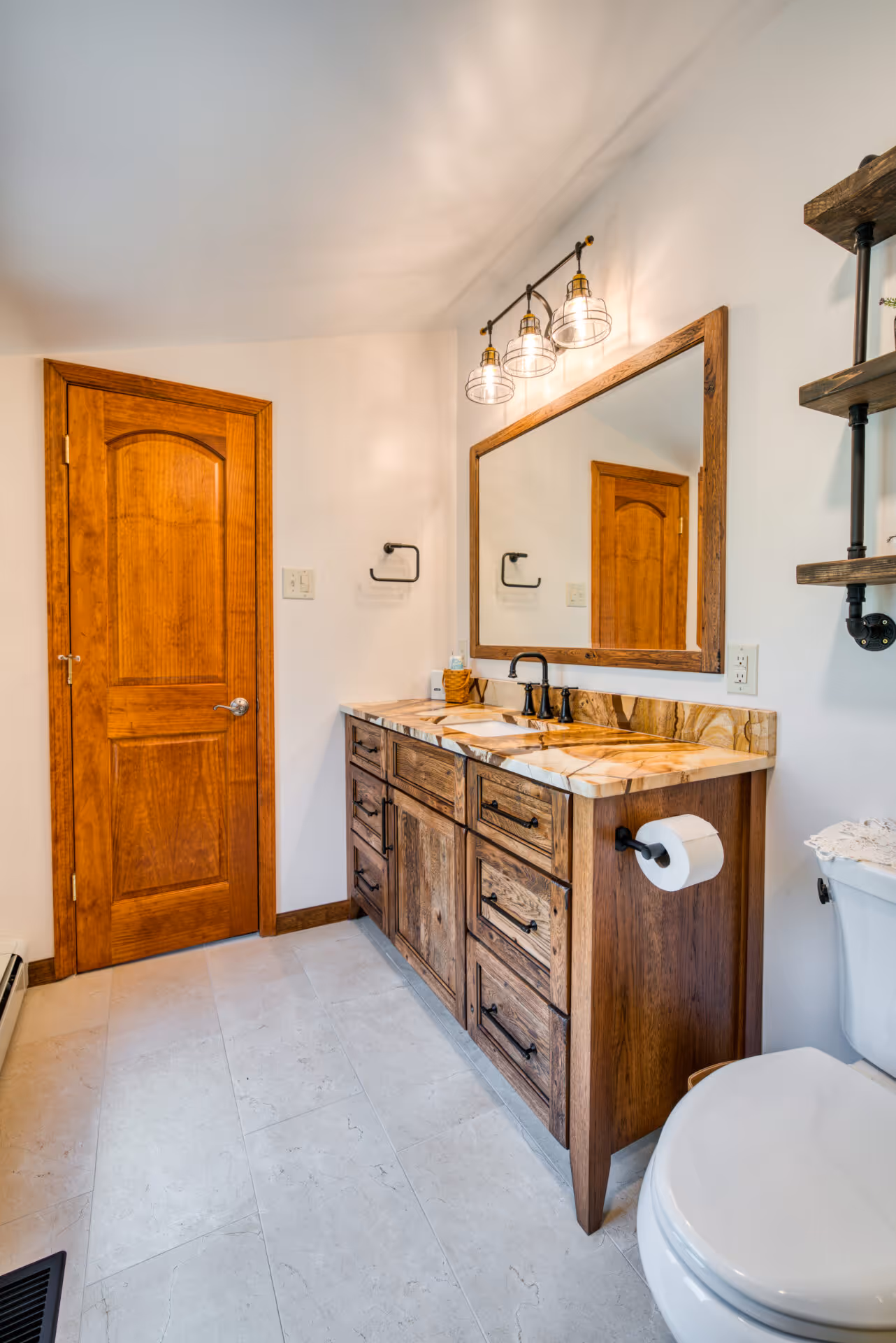 Transitional bathroom in Dillsburg, PA featuring a rustic double vanity with a stone countertop and stylish fixtures