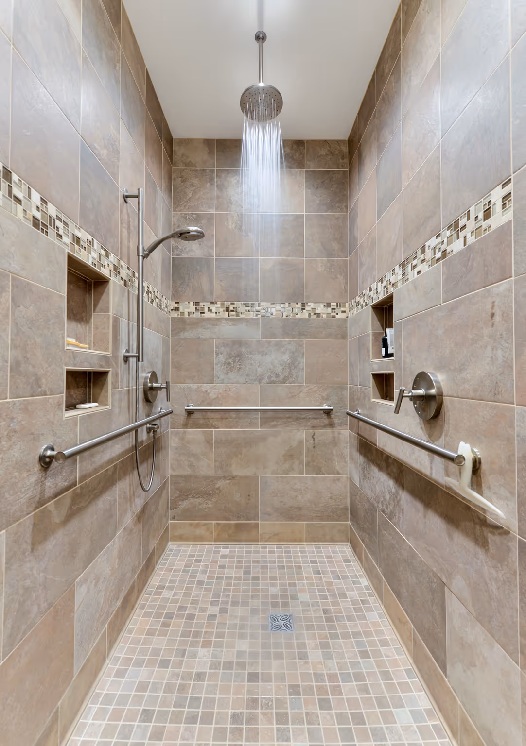 Modern shower with elegant tiles and large rainfall showerhead, featuring grab bars for safety in Carlisle, PA.