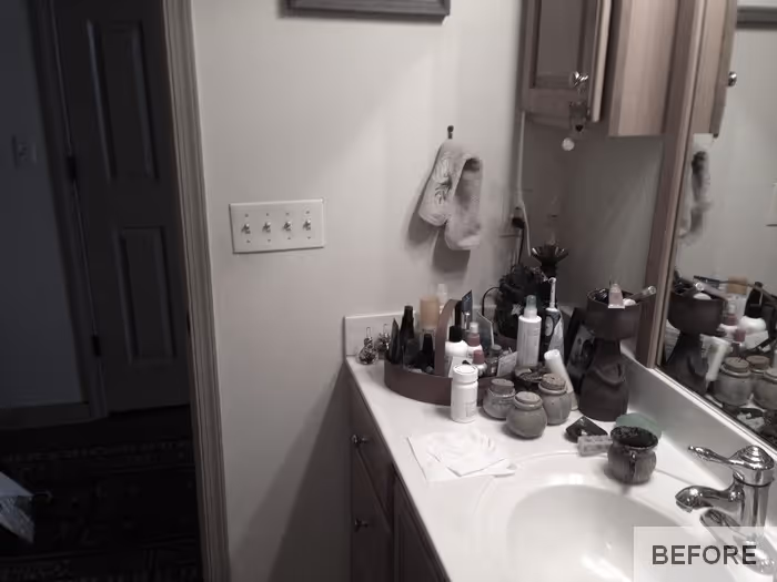 Update your bathroom with a cluttered countertop featuring skincare products and earthy tones in Carlisle, PA.