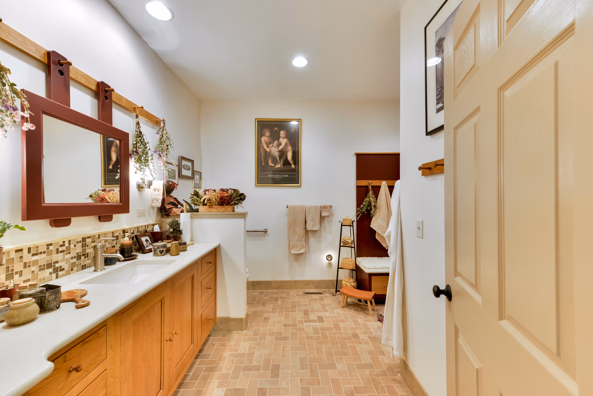 Transitional bathroom featuring a dual-sink vanity, rustic decor, and warm lighting in carlisle, pa.