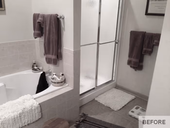 Transitional bathroom with a jetted tub, glass shower, and gray towels located in Carlisle, PA