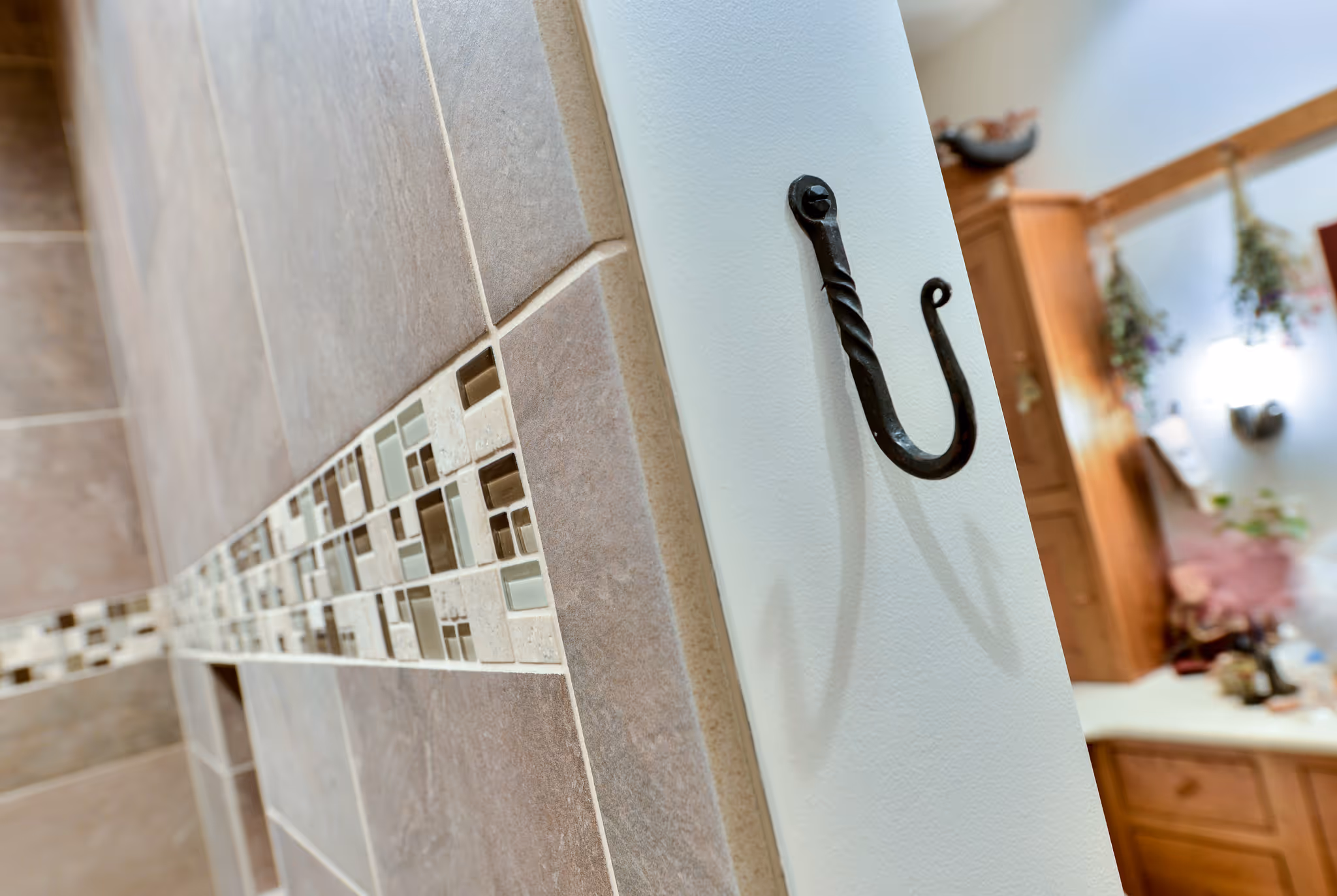 Contemporary bathroom with mosaic tile accents and dark wall hook in Carlisle, PA