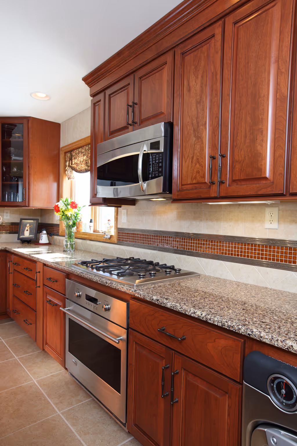 Warm wood kitchen cabinets with granite countertops and stainless steel appliances in a York, PA home.