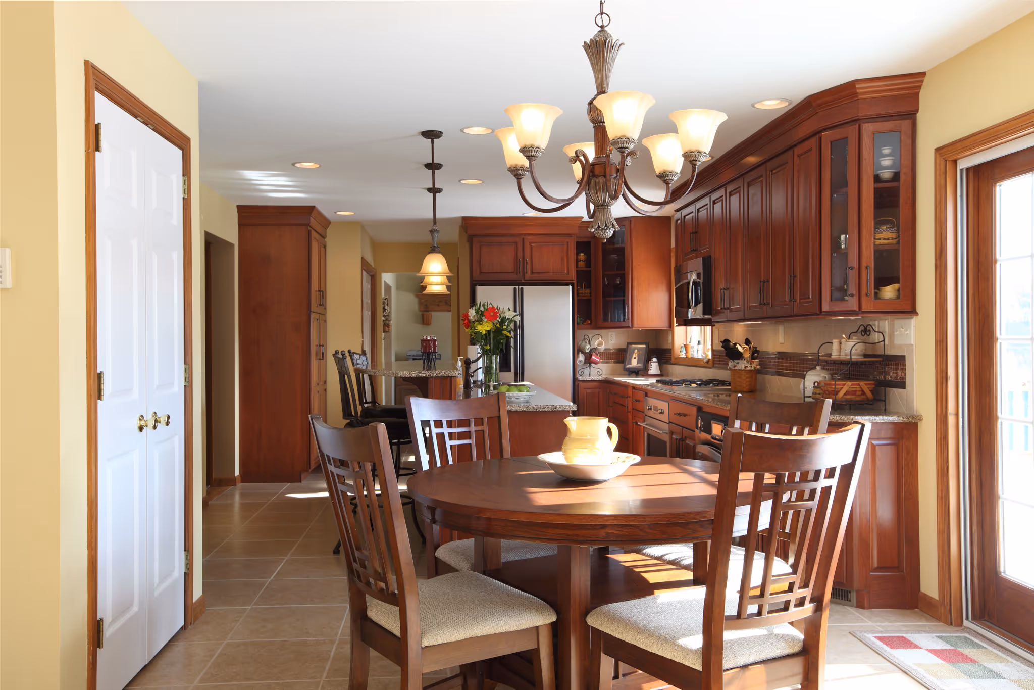 Cozy modern kitchen with wooden cabinetry and a circular dining table, located in York, PA.