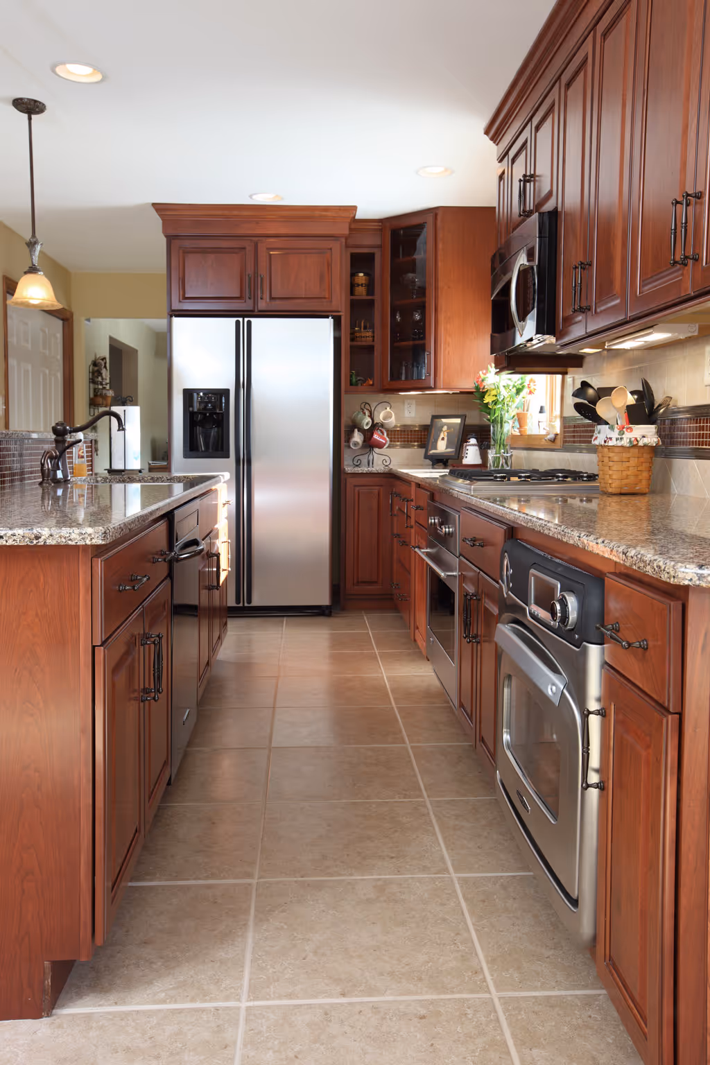 Stunning kitchen in York, PA featuring dark wood cabinets, granite countertops, and contemporary appliances.