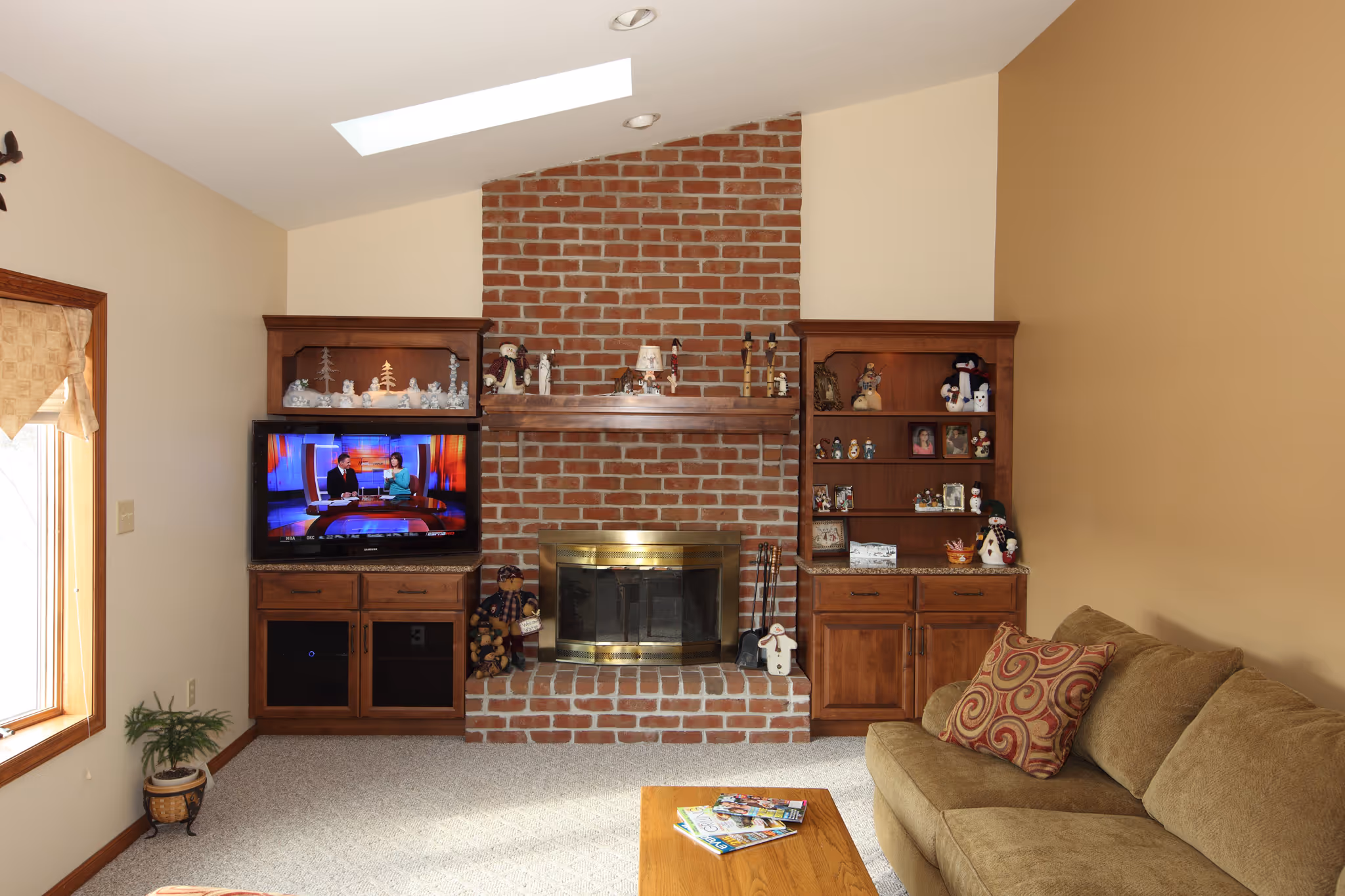 Cozy living room featuring a brick fireplace, wooden shelving, and comfortable seating in york, pa.