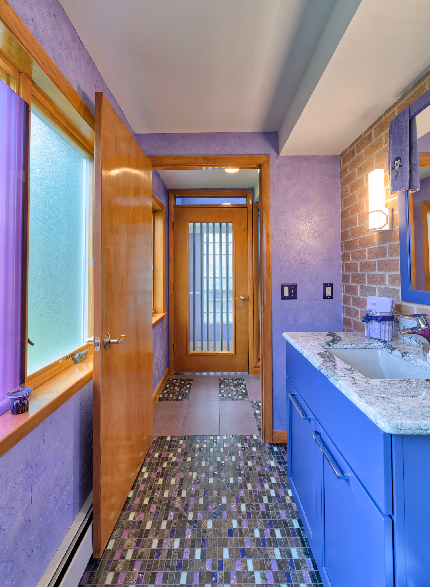 Vibrant purple bathroom with mosaic tile flooring and modern vanity in Camp Hill, PA.