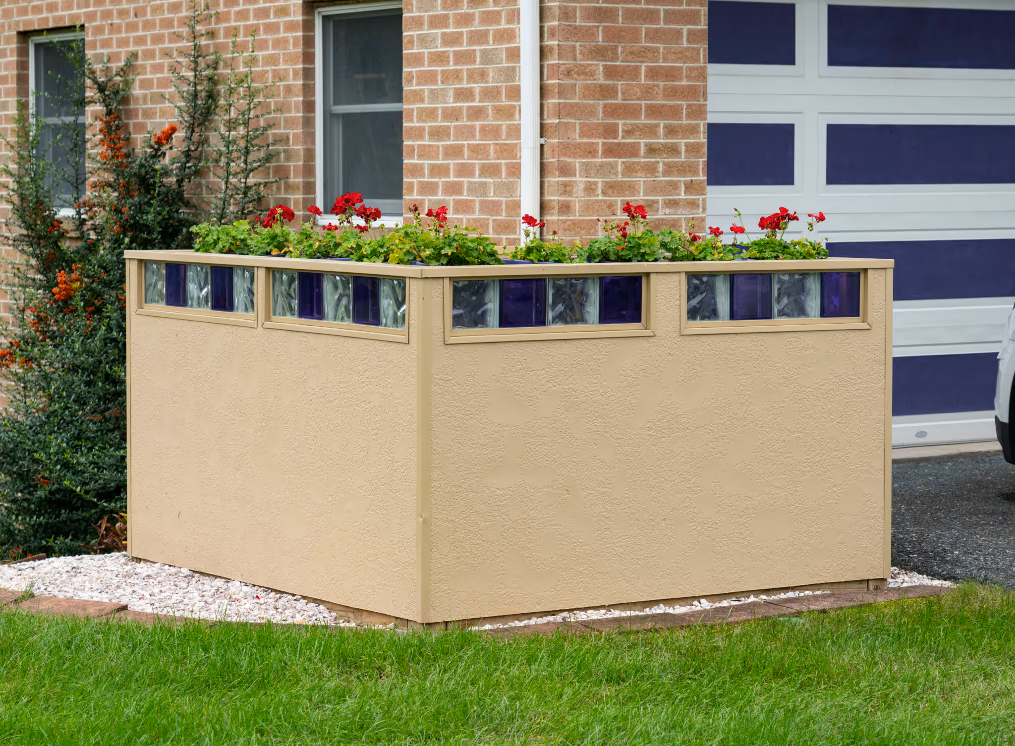 Outdoor planter box featuring vibrant flowers and decorative glass accents in Camp Hill, PA.
