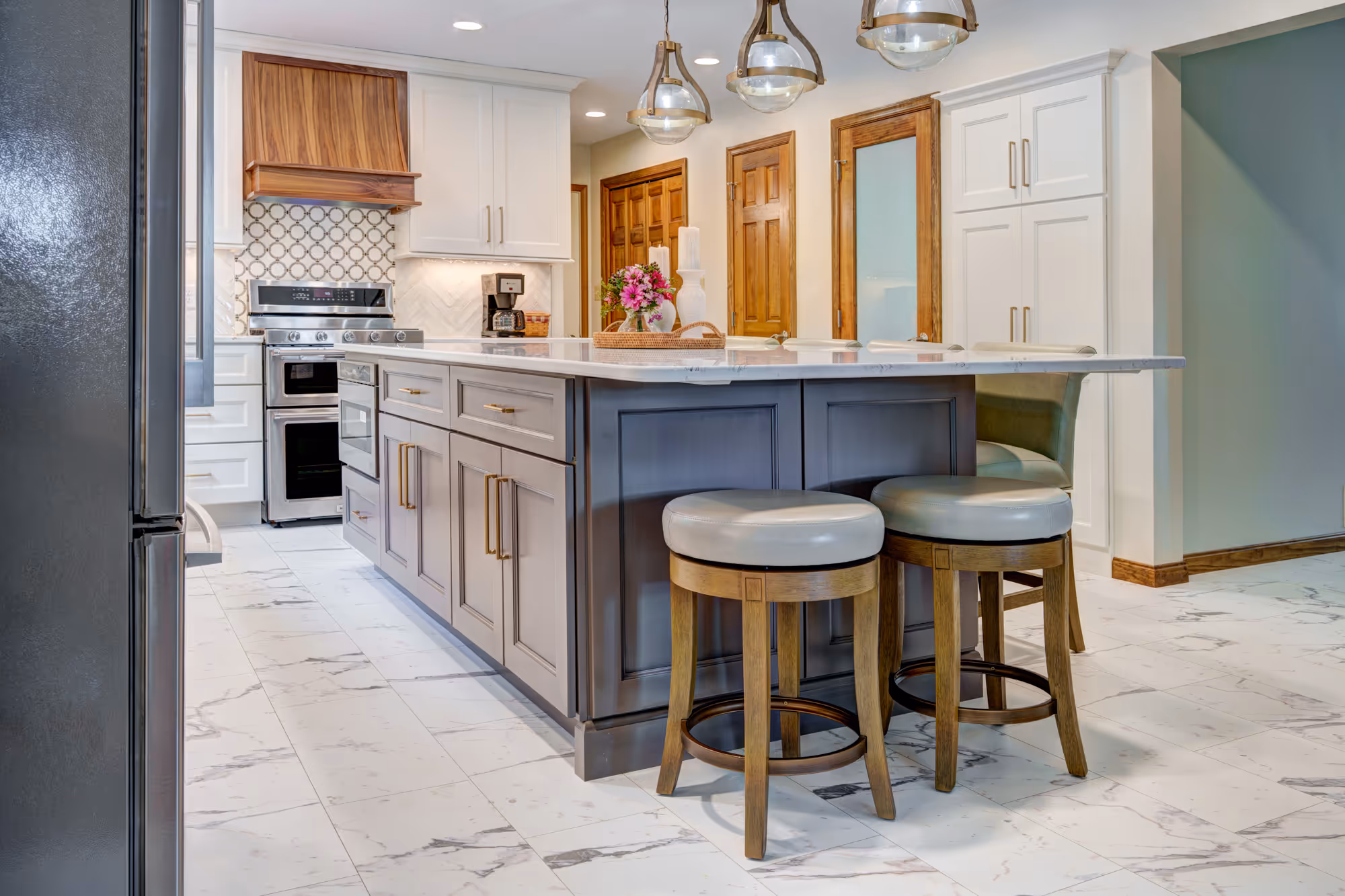 Modern kitchen remodel featuring a stylish island with seating, marble countertops, and wood accents in gettysburg, pa.