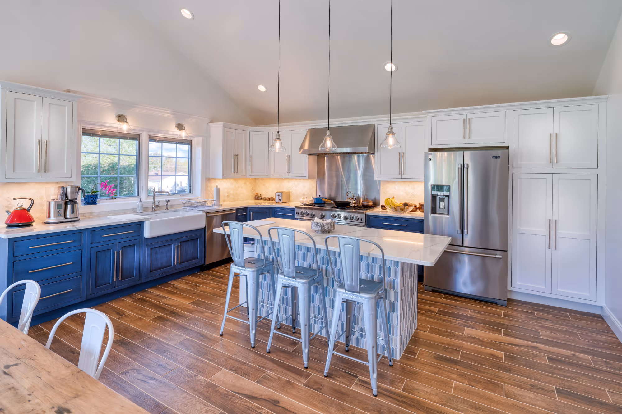 Modern Etters, PA kitchen featuring blue cabinets, stainless steel appliances, and a spacious layout with a hexagon tile island.