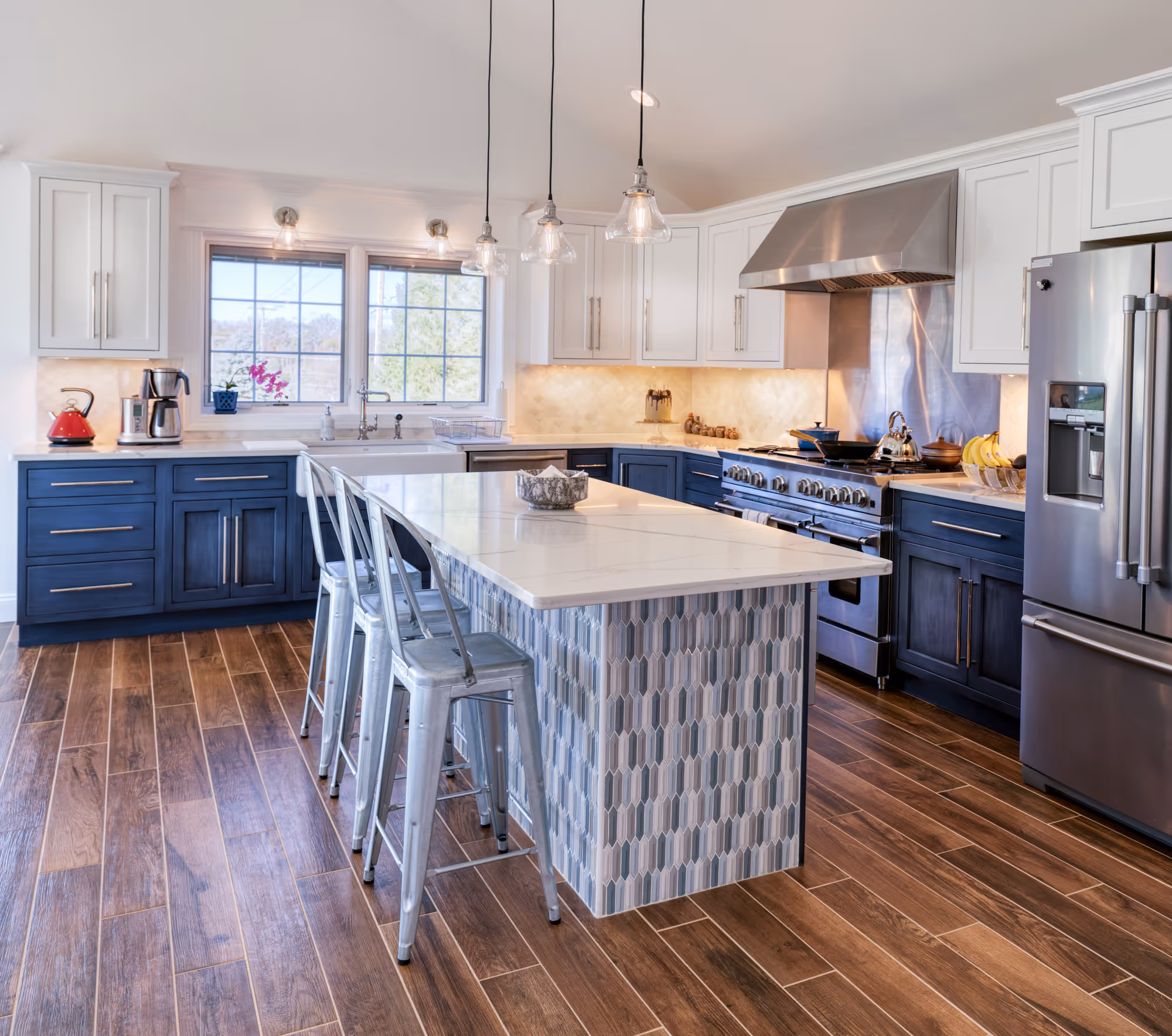 Modern kitchen in etters, pa featuring blue cabinetry, white countertops, and stylish bar seating.
