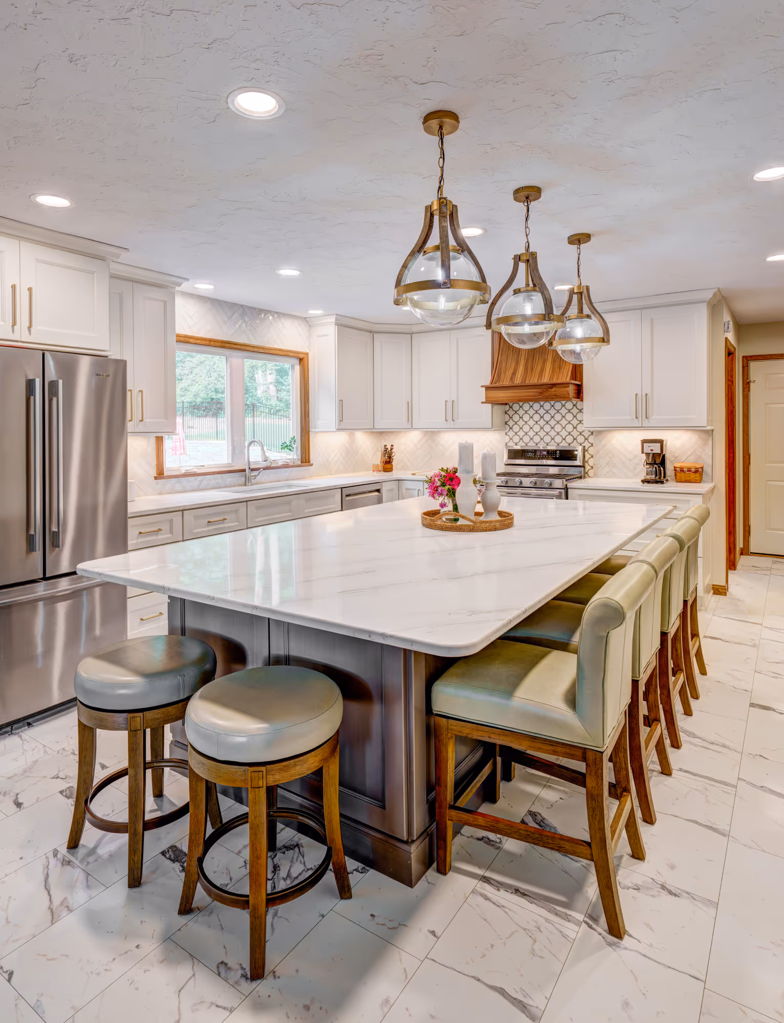 Modern kitchen in Gettysburg, PA with marble island, elegant pendant lights, and stylish bar seating.