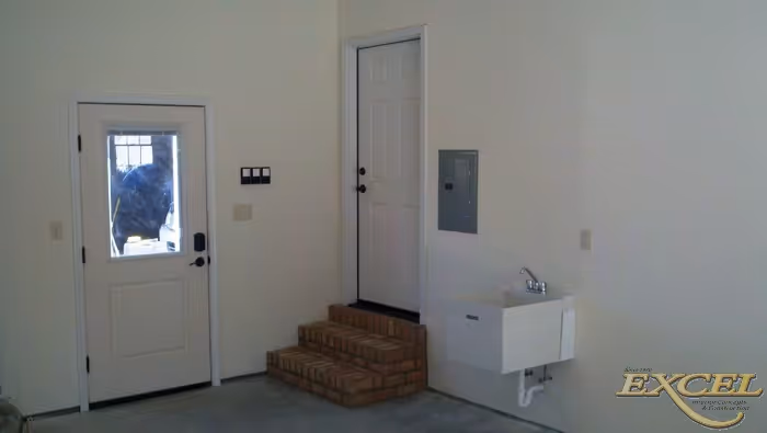 Modern entryway in Harrisburg, PA featuring a brick step and utility sink with white walls.