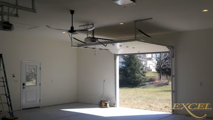 Spacious modern garage interior with a door leading outside in harrisburg, pa, featuring ceiling fans and ample natural light.