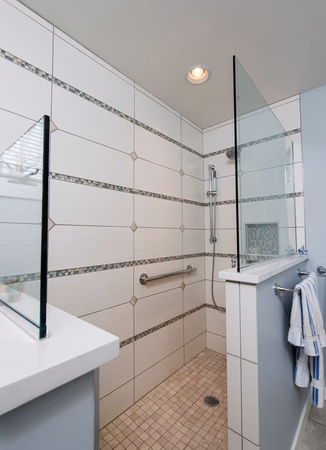 Contemporary bathroom shower in Hummelstown, PA, featuring tiled walls, glass panels, and sleek fixtures.