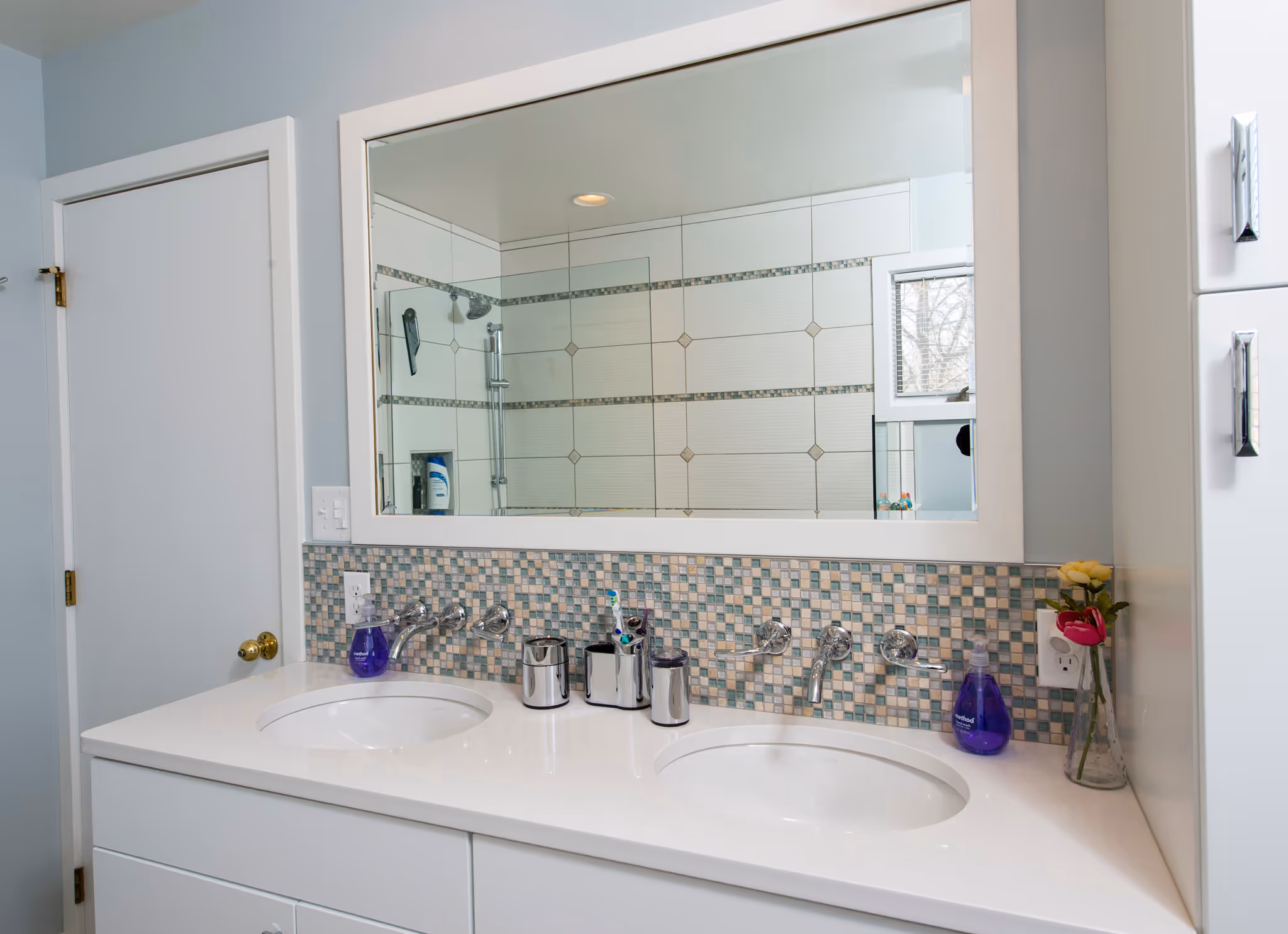 Modern bathroom with double sinks and mosaic tile backsplash in Hummelstown, PA.