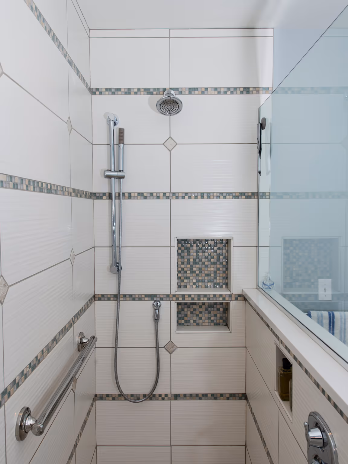 Contemporary bathroom shower with mosaic tile accents and glass enclosure in Hummelstown, PA
