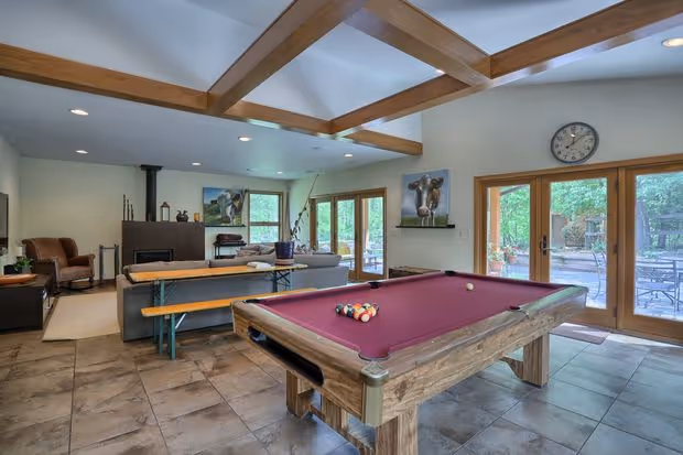 Spacious game room featuring a billiards table, modern decor, and large windows in mechanicsburg, pa.