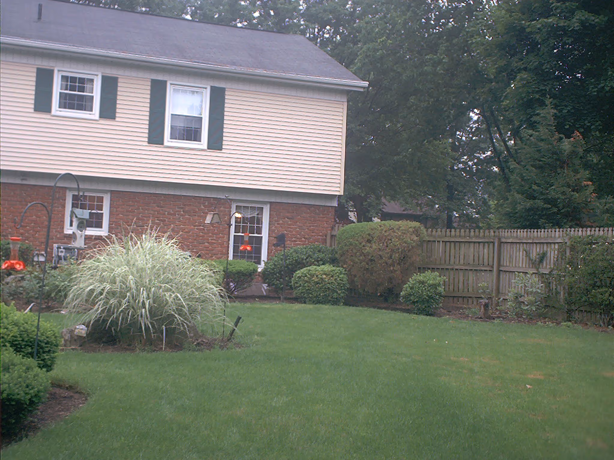 Charming exterior of a two-story home in Camp Hill, PA featuring lush greenery and a well-maintained lawn.