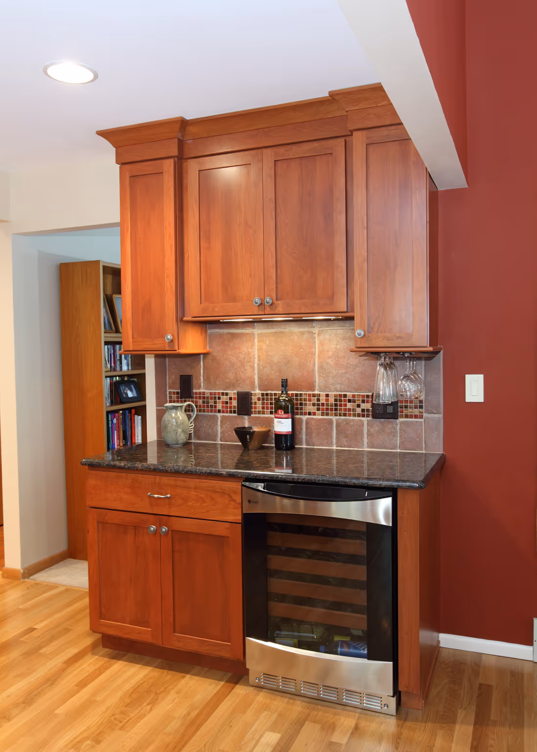 Cozy transitional kitchen with cherry wood cabinets, granite countertop, and wine fridge in Carlisle, PA.
