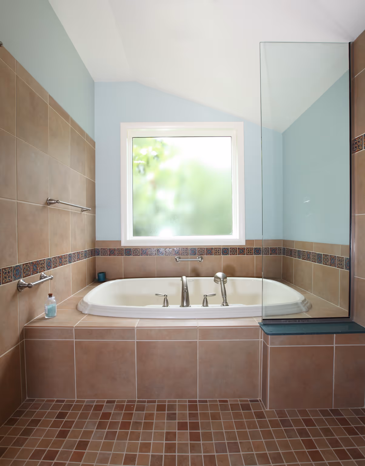 Luxury bathroom with a freestanding tub, glass shower enclosure, and decorative tile accents in Carlisle, PA.