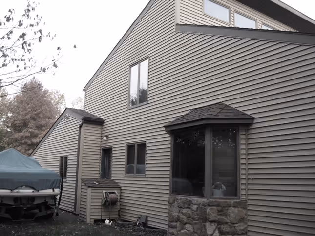 Contemporary exterior view of a residential home in Carlisle, PA featuring a mix of siding and stone.