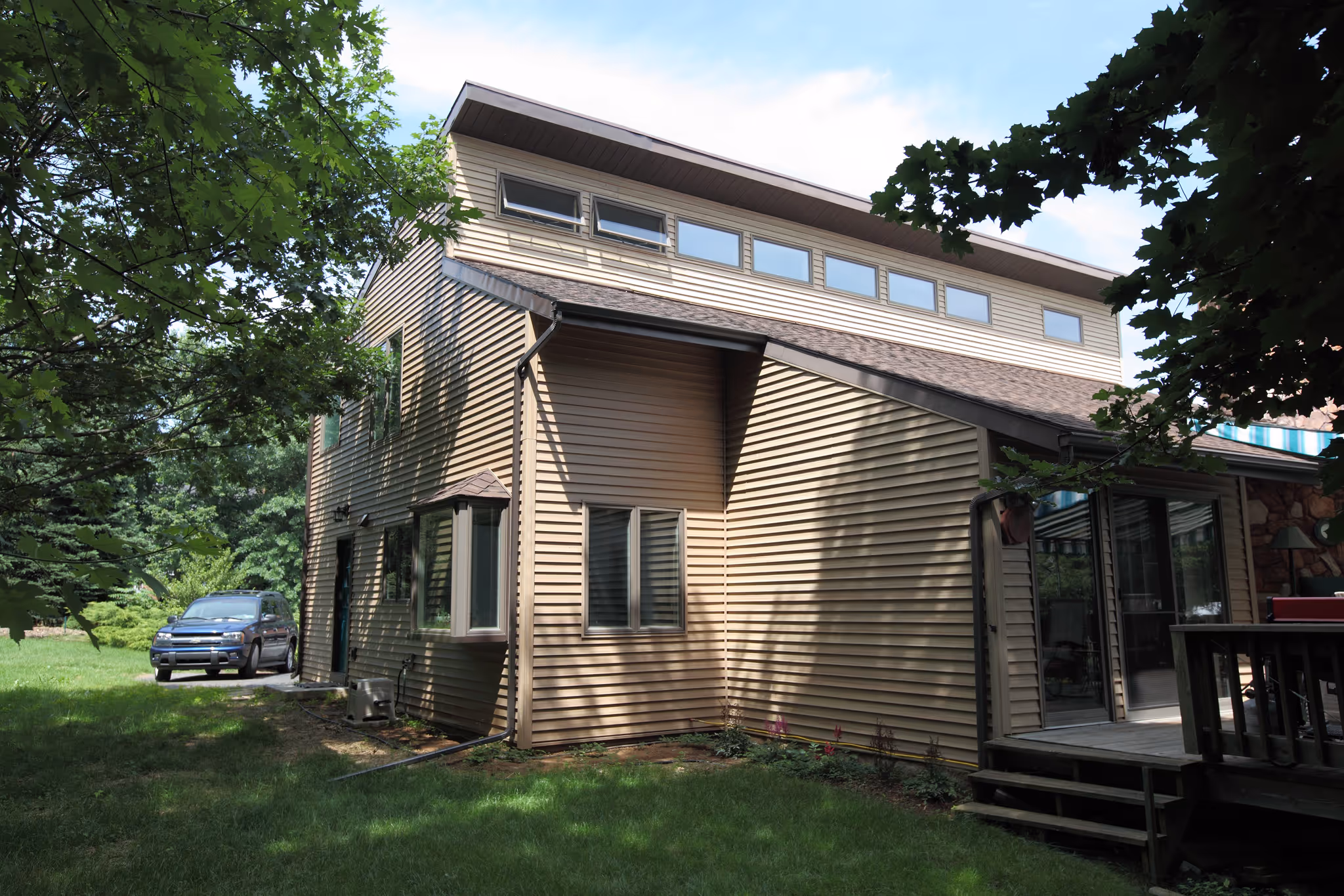 Contemporary exterior home design featuring wood siding and large windows in Carlisle, PA.