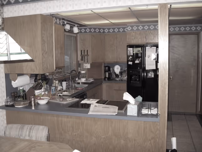 Modern kitchen featuring wood cabinets and gray countertops in Carlisle, PA.