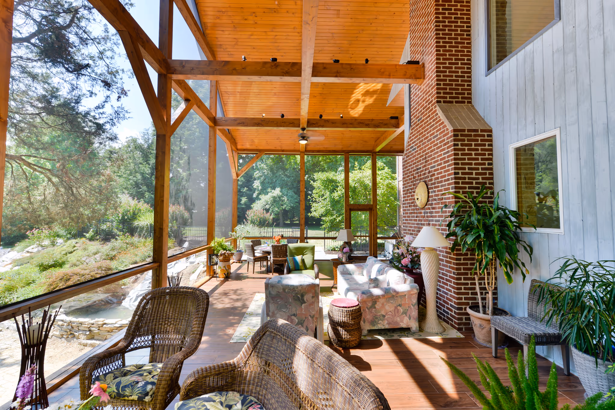 Bright and airy sunroom featuring wicker furniture and vibrant plants in Camp Hill, PA.