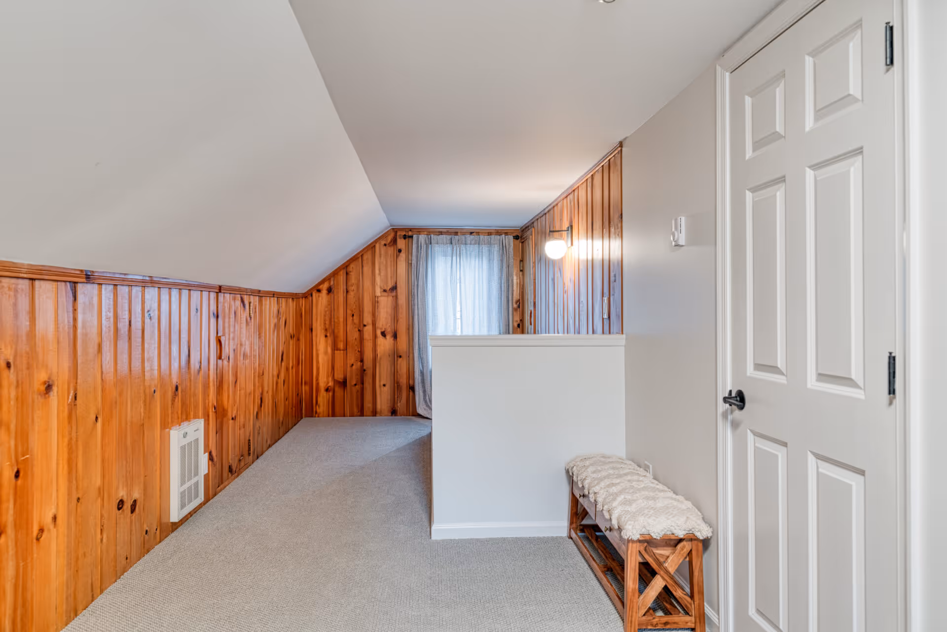 Cozy transitional bathroom featuring warm wood walls and soft carpeting in New Cumberland, PA.