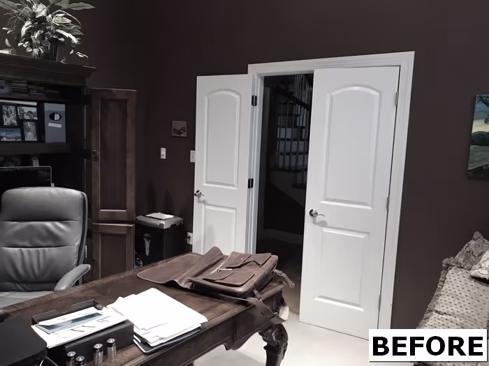 Home office with brown walls, wooden desk, and gray chair located in mechanicsburg, pa.