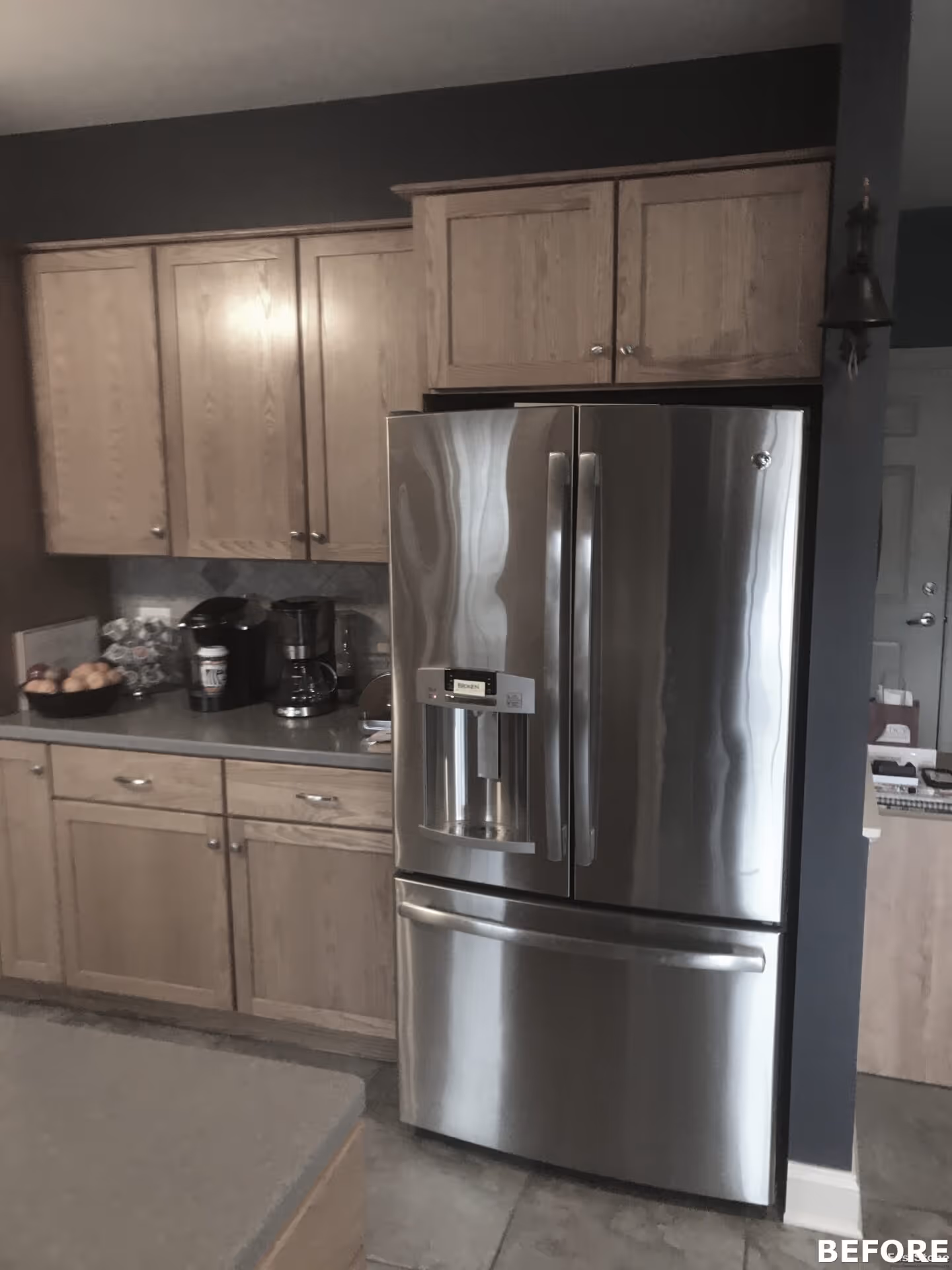 Modern kitchen with wood cabinets, stainless steel refrigerator, and a gray countertop in mechanicsburg, pa