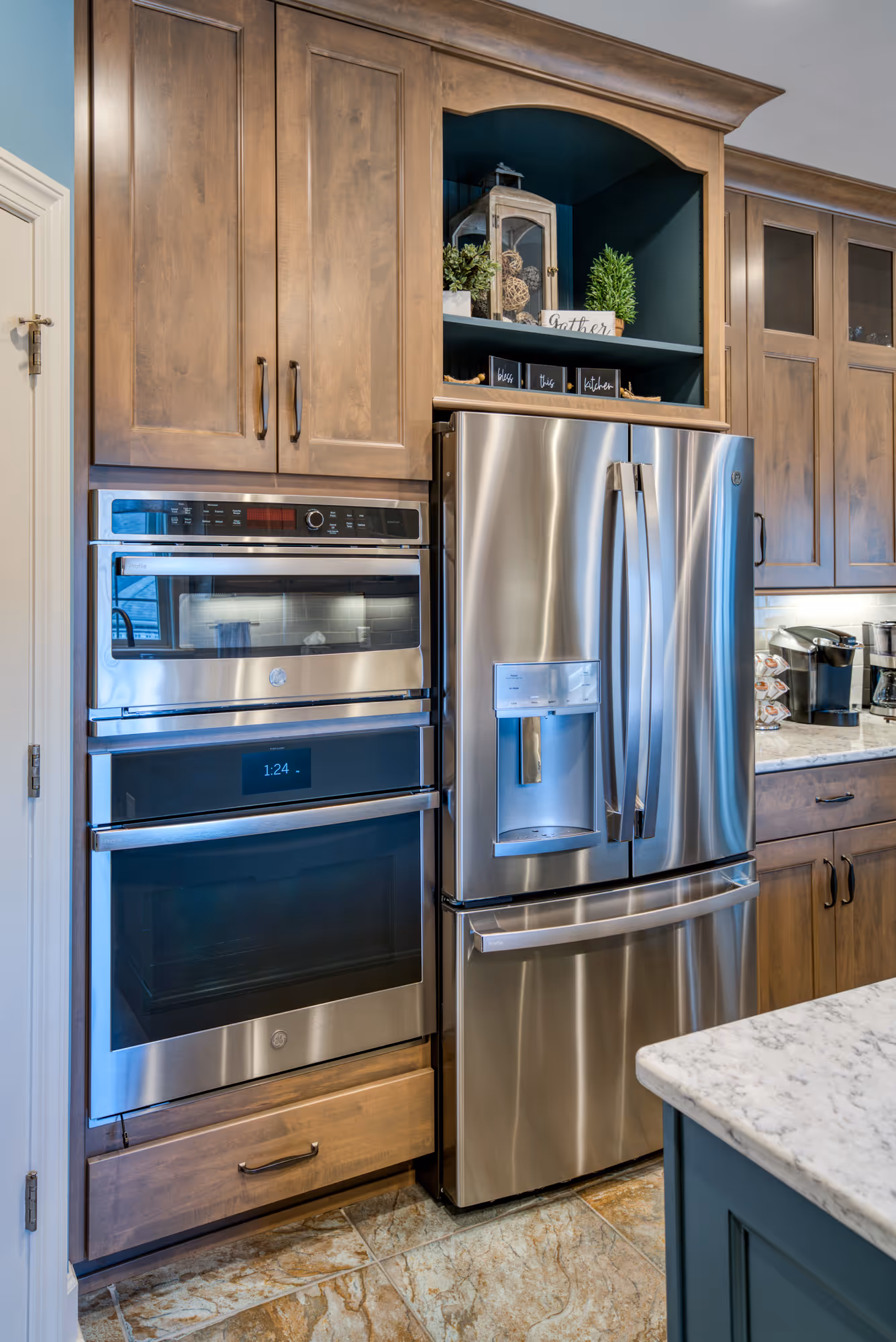 Modern kitchen in Mechanicsburg, PA featuring dark wood cabinetry, stainless steel appliances, and stylish decor elements.