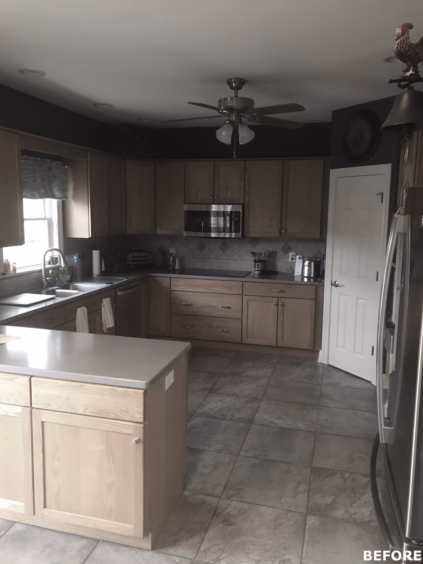 Spacious transitional kitchen in mechanicsburg, pa featuring light wood cabinets, gray tiled floor, and modern appliances.