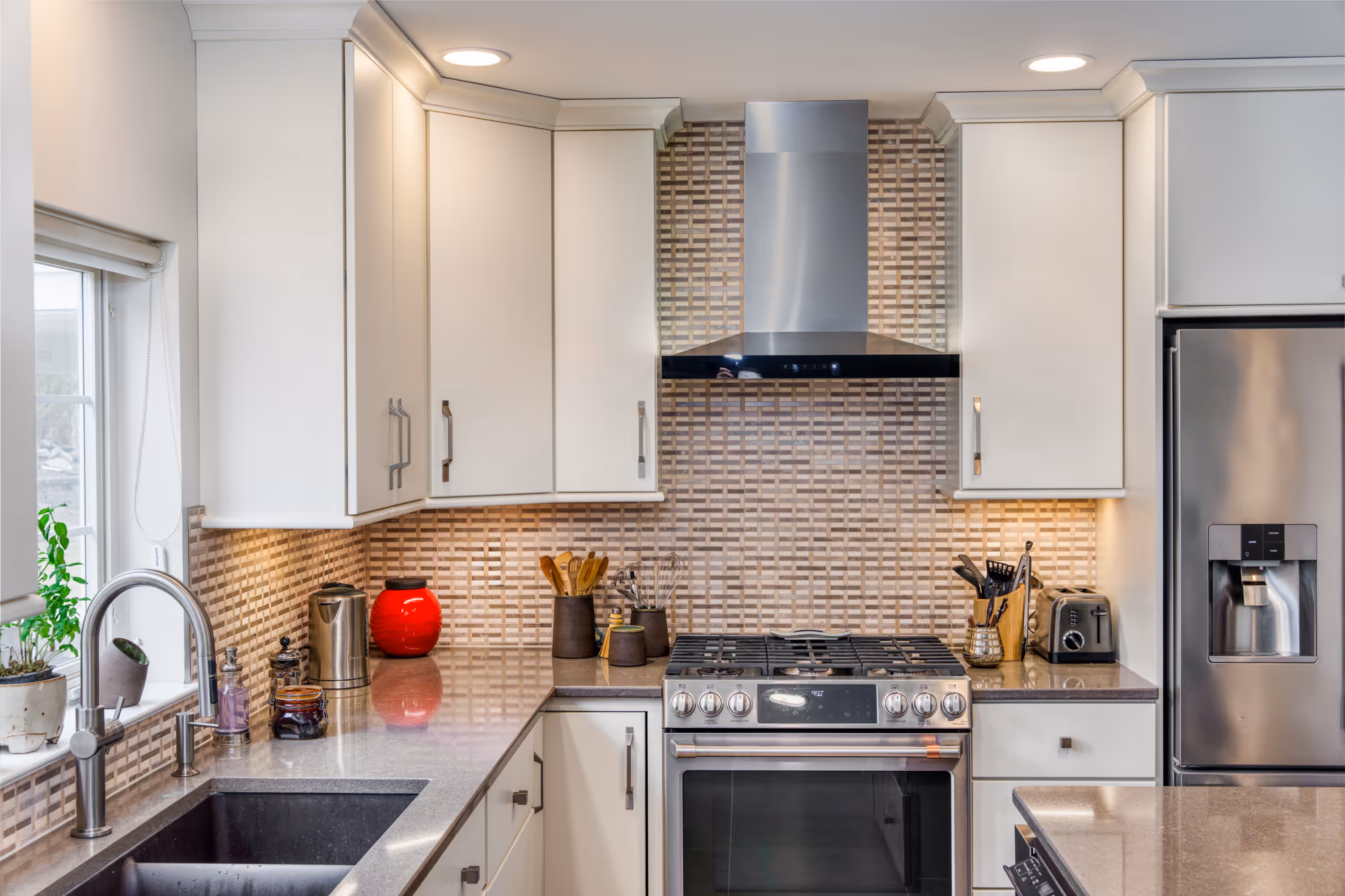 Modern kitchen in Hummelstown, PA featuring sleek white cabinets, stainless steel appliances, and a stylish backsplash.