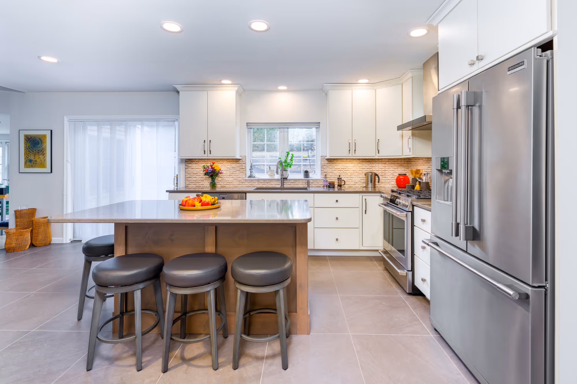 Contemporary kitchen in Hummelstown, PA featuring a modern island, sleek cabinetry, and stylish bar stools.