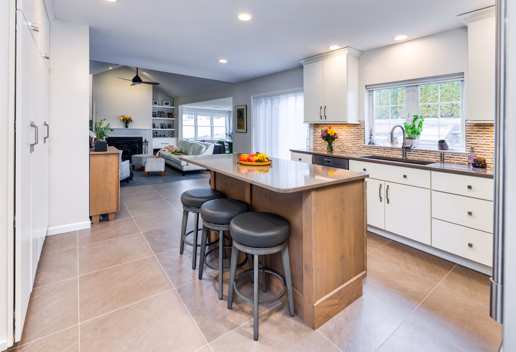 Modern open kitchen with an island and seating area in hummelstown, pa, featuring a warm color palette and sleek cabinetry.