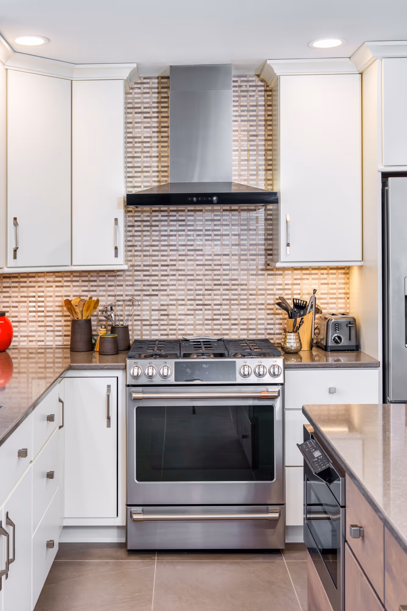 Modern kitchen with stainless steel appliances, white cabinetry, and stylish tile backsplash in hummelstown, pa.