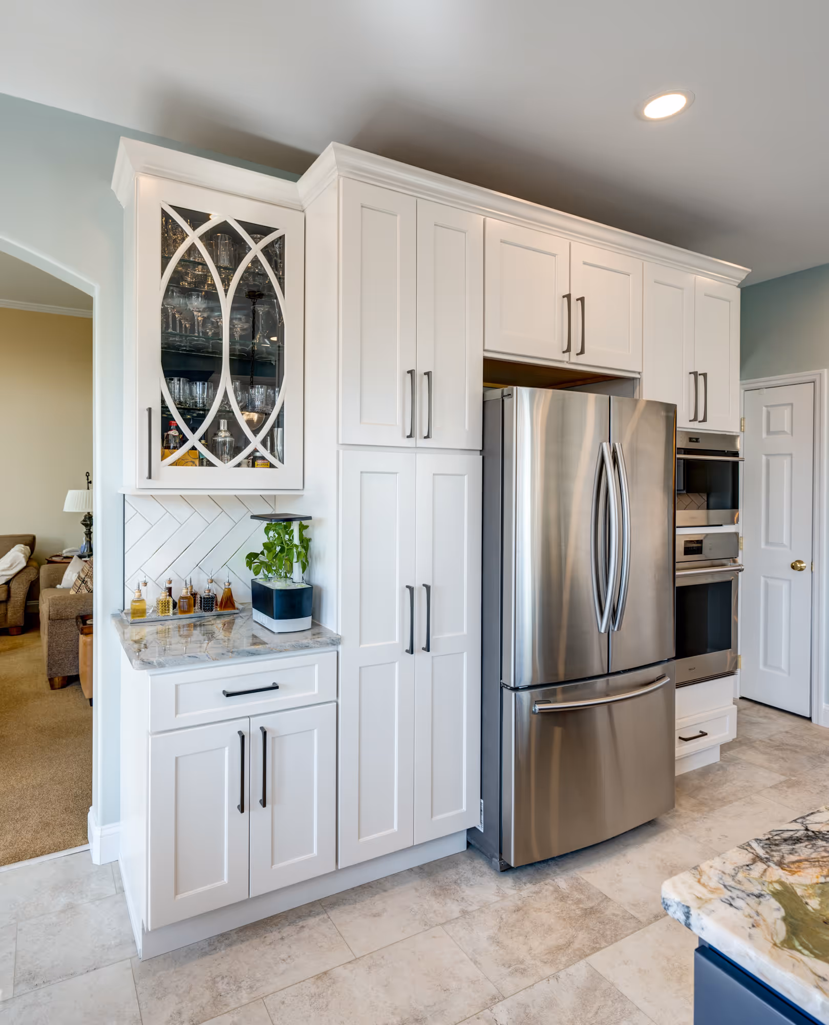 Stylish kitchen featuring white cabinetry, stainless steel appliances, and a marble countertop in enola, pa.