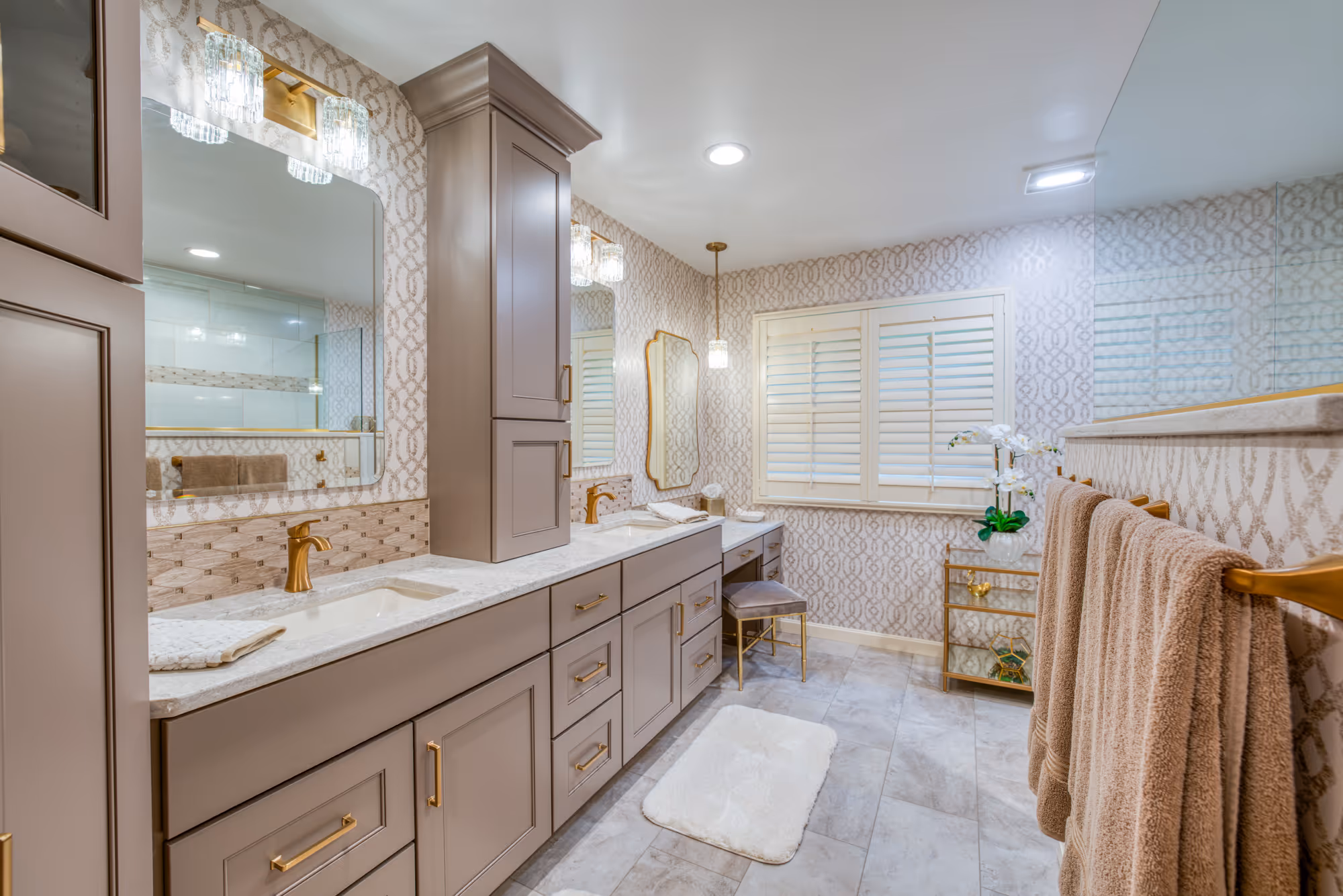 Primary bathroom remodel in Mechanicsburg, PA featuring light brown cabinetry, a double vanity, and elegant decor.