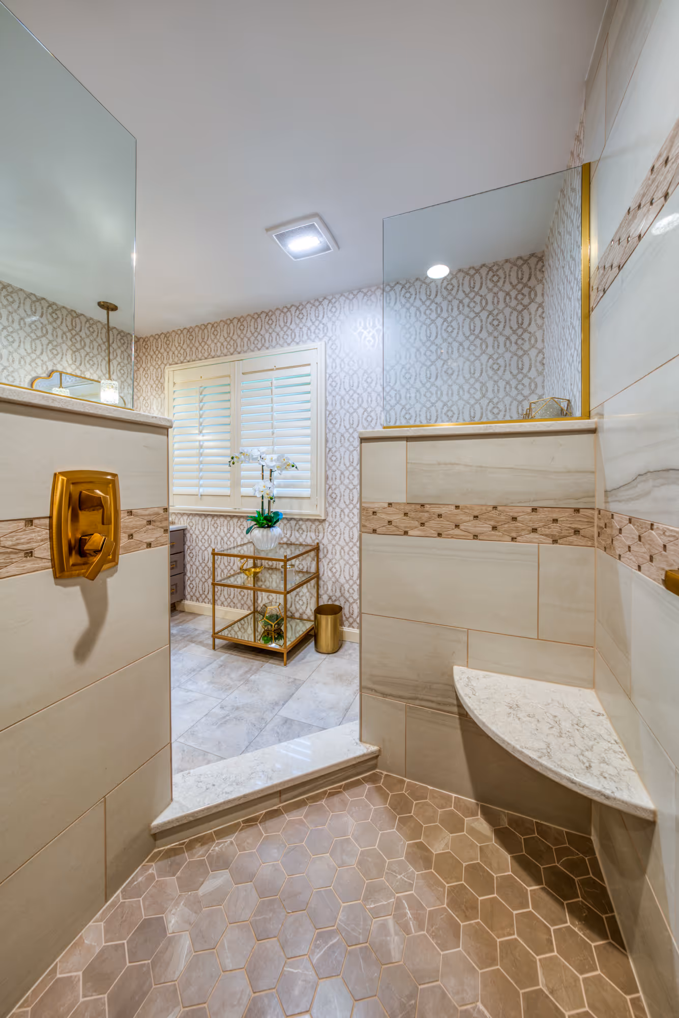 Elegant primary bathroom in Mechanicsburg, PA with hexagon tile flooring and gold accents, featuring a stylish shower area.