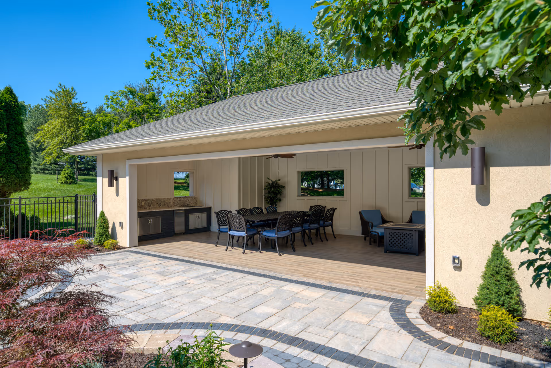 Outdoor pool house in mechanicsburg, pa featuring modern design, a spacious patio, and stylish seating.