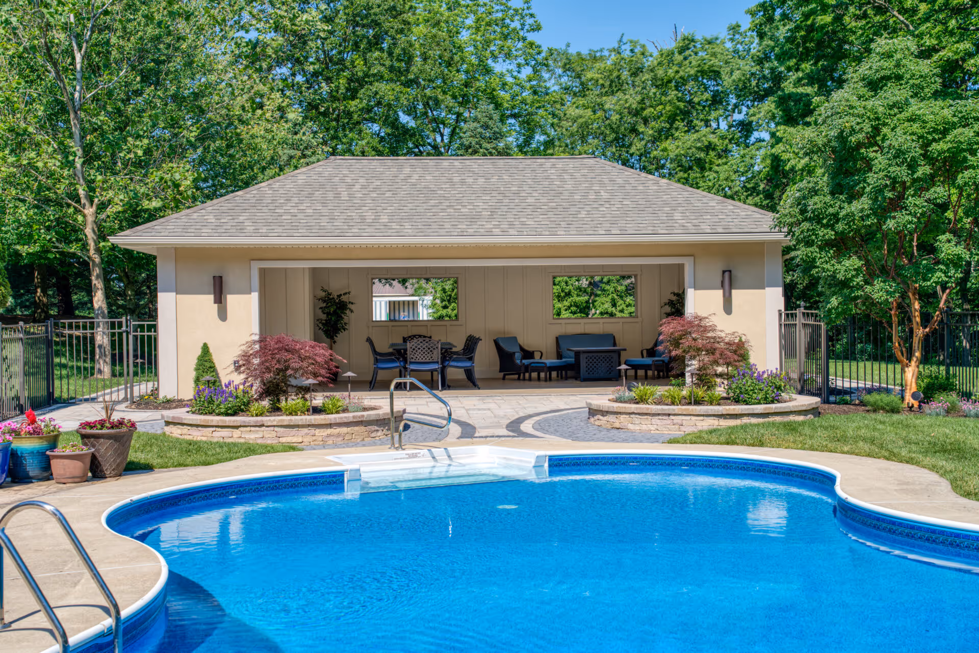 Modern pool house with outdoor seating and landscaped greenery in Mechanicsburg, PA