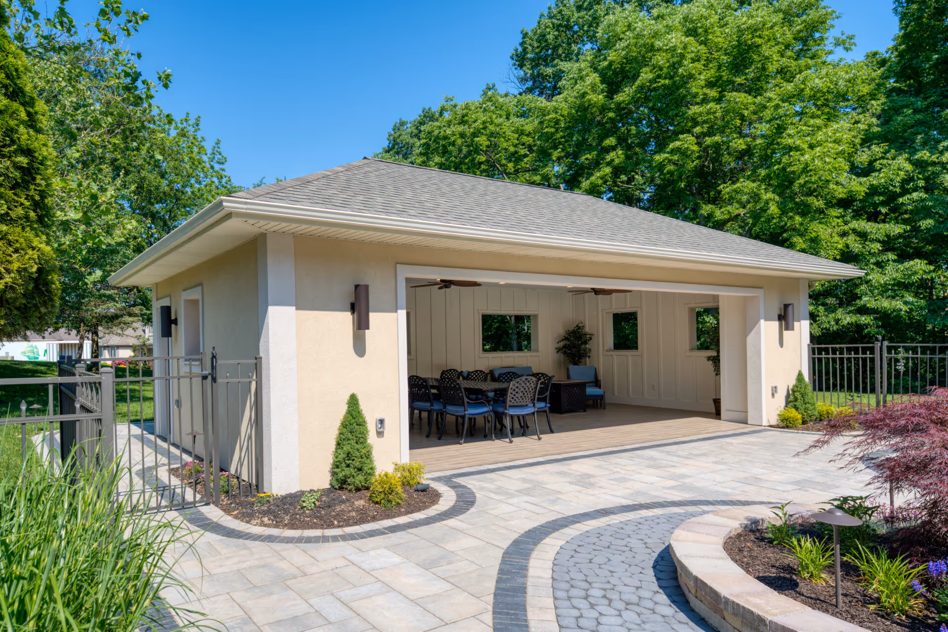 Modern outdoor poolhouse in Mechanicsburg, PA with seating and natural surroundings