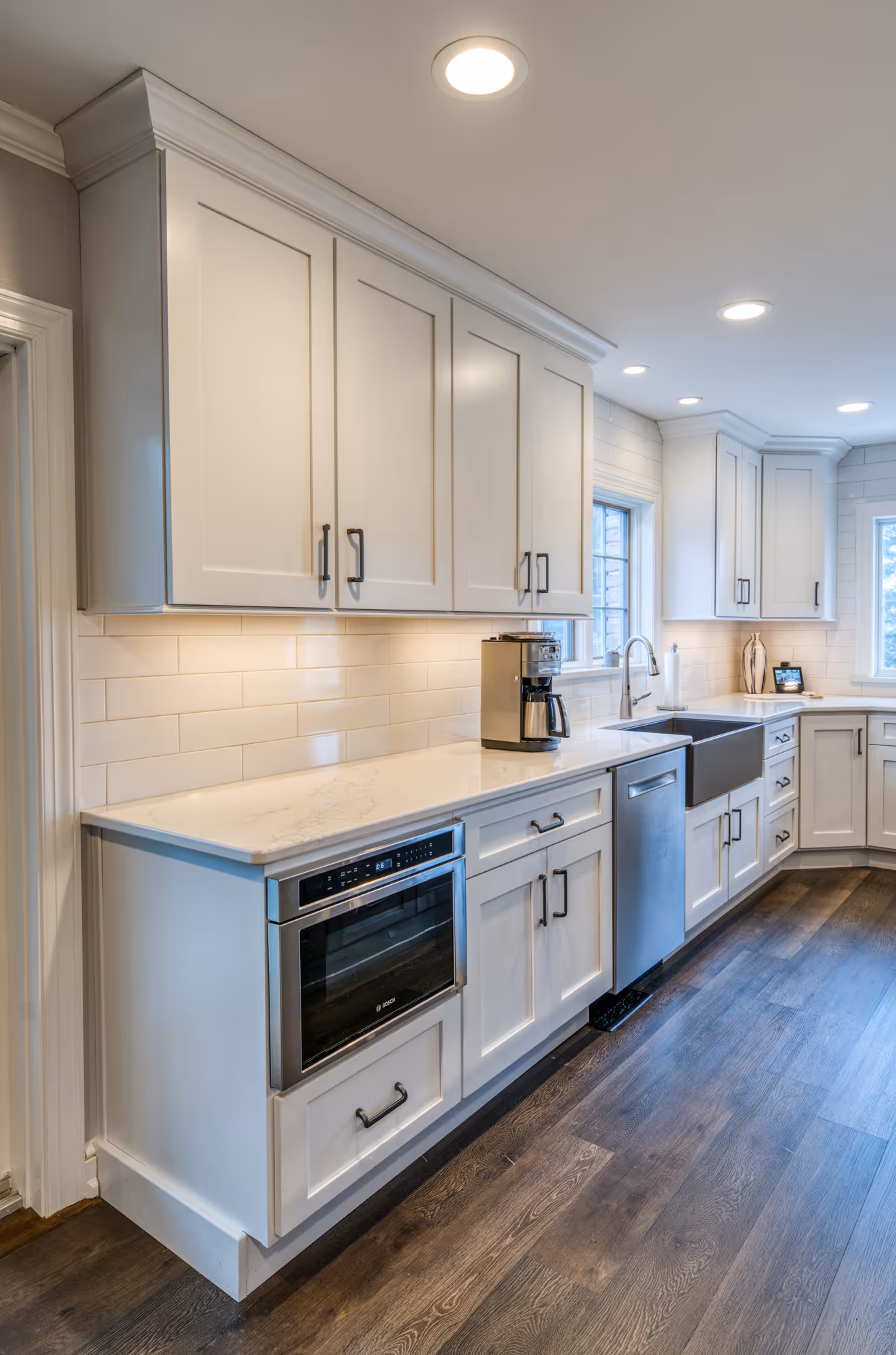 Modern kitchen in marysville, pa with white cabinets, marble countertops, and stainless steel appliances.